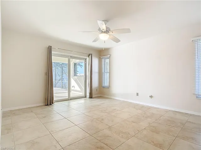 Unfurnished room with ceiling fan and light tile patterned floors