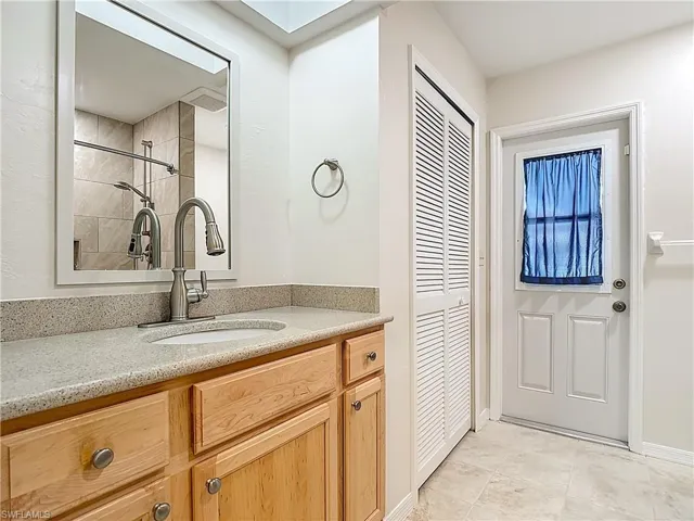 Downstairs Pool Bath and Full bathroom with a stall shower and tile patterned floors