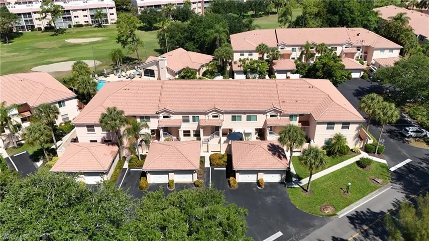 Aerial perspective showcasing a multi-unit residential complex with terracotta-style tile roofs