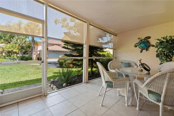 Screened patio featuring tile flooring and textured walls