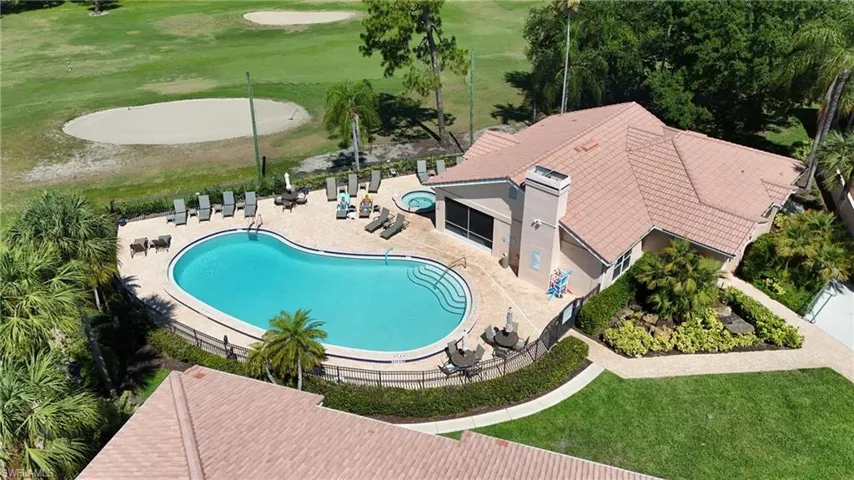 Outdoor swimming pool with integrated spa and paver surround