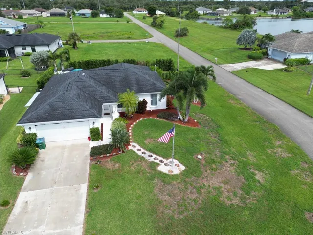 Aerial perspective of suburban area featuring a large body of water