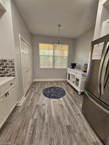 Dining space featuring baseboards and wood finished floors