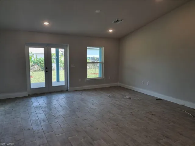 Single story home with a garage, concrete driveway, and stucco siding