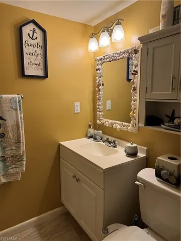 Bathroom featuring vanity and marble finish flooring
