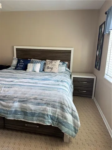 Bedroom featuring baseboards and carpet