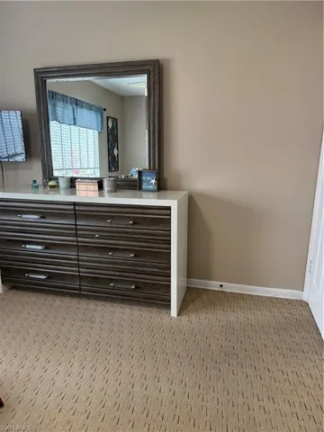 Detailed view of carpet flooring and baseboards