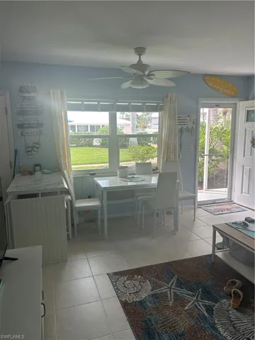 Dining space featuring light tile patterned floors and a ceiling fan