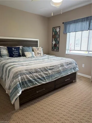 Bedroom with baseboards and carpet flooring