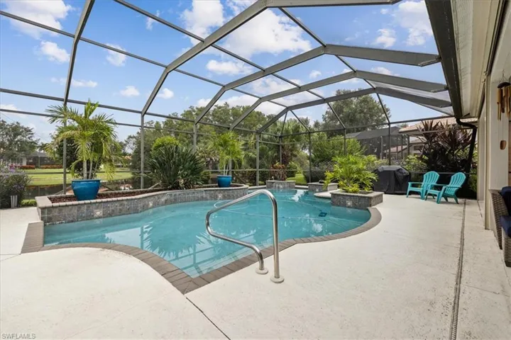 View of pool featuring pool water feature, a patio area, and a lanai