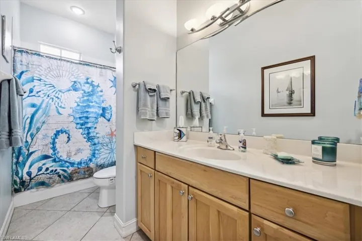 Bathroom with vanity, tile patterned flooring, and toilet