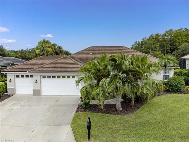 View of front of house with a garage and a front yard