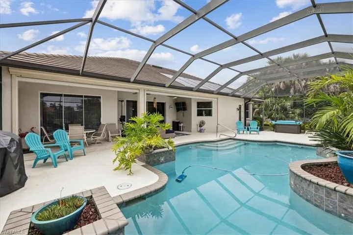 View of swimming pool with a patio and glass enclosure