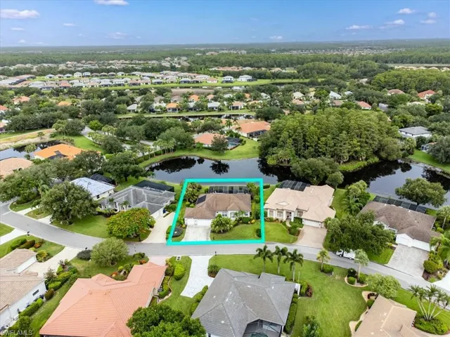 Birds eye view of property with a water view