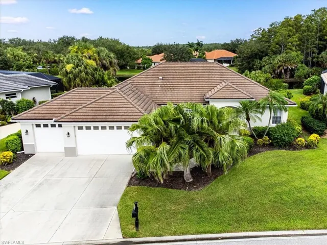 View of front of home featuring a garage and a front lawn