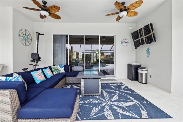Living room with carpet floors and ceiling fan