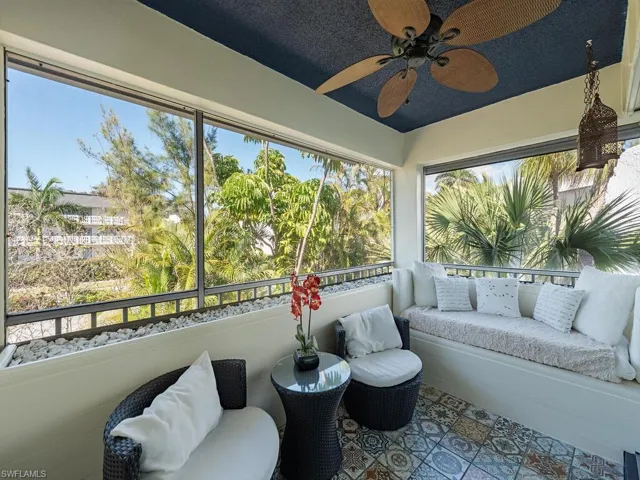 Sunroom featuring an outdoor living space, a healthy amount of sunlight, and a ceiling fan