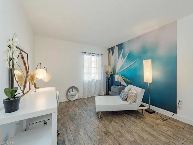 Living area with wood finished floors and baseboards