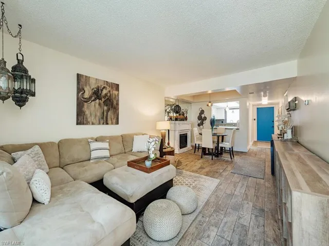 Living room featuring a textured ceiling and wood finished floors