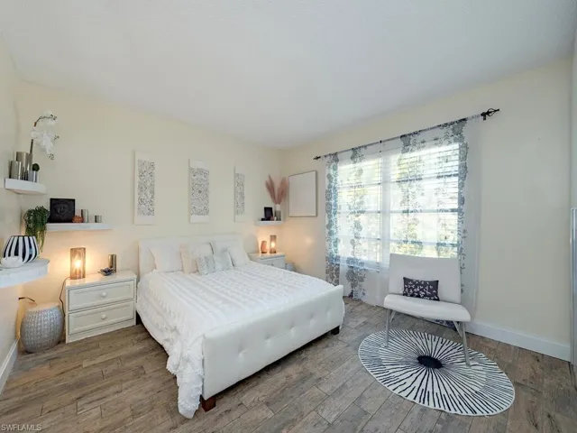 Bedroom with baseboards and wood finished floors