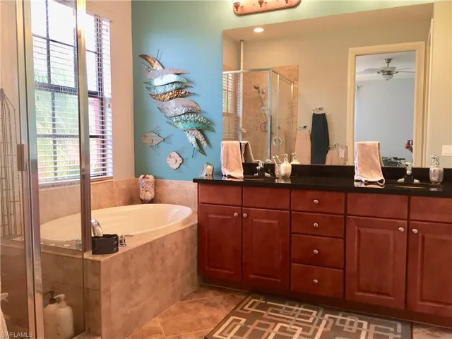 Double vanity, large spa tub and walk in shower with large walk in closet