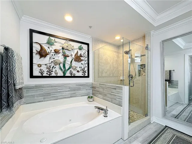 Bathroom with plus walk in shower and ornamental molding