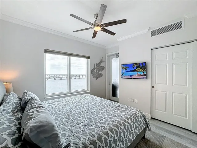 Bedroom featuring ornamental molding, ceiling fan, and hardwood / wood-style floors