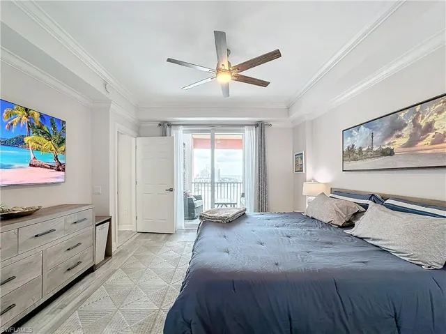 Bedroom featuring access to exterior, ceiling fan, and ornamental molding