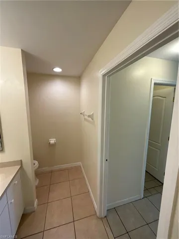 Bathroom with tile patterned flooring, vanity, and toilet