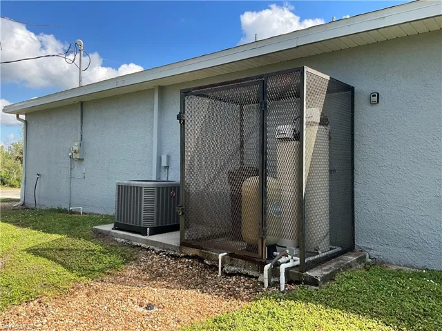 View of side of property with central air conditionand water system.