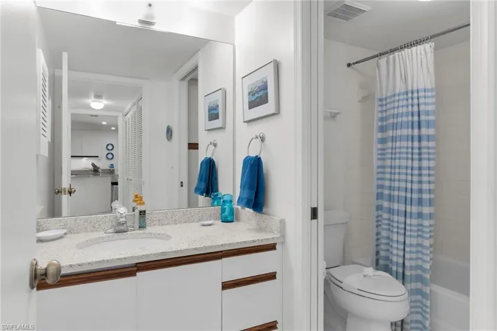Bathroom with vanity and shower / tub combo