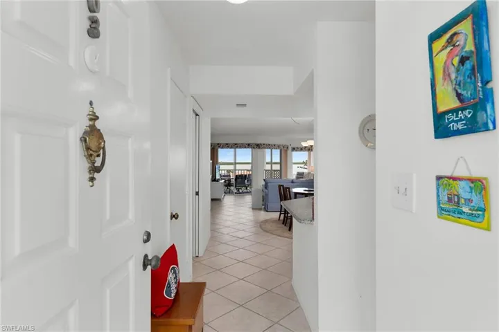 Hallway featuring light tile patterned flooring