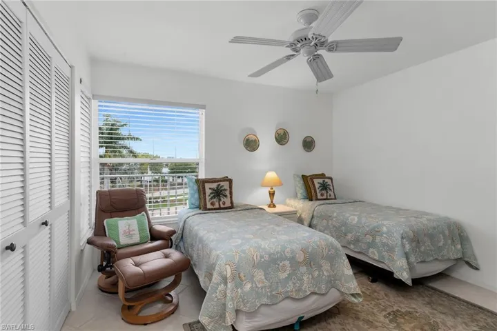 Tiled bedroom featuring a closet and ceiling fan