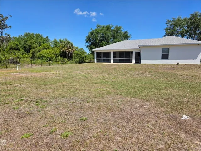 Oversized fenced-in yard with two large gates.