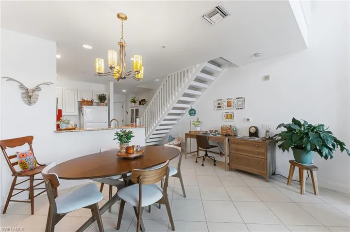 Spacious room featuring high ceilings, light tile flooring, and a multi-level layout