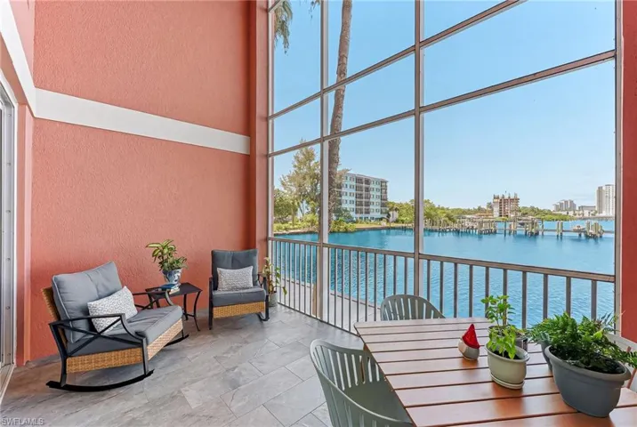 Screened balcony featuring expansive water views and tile flooring