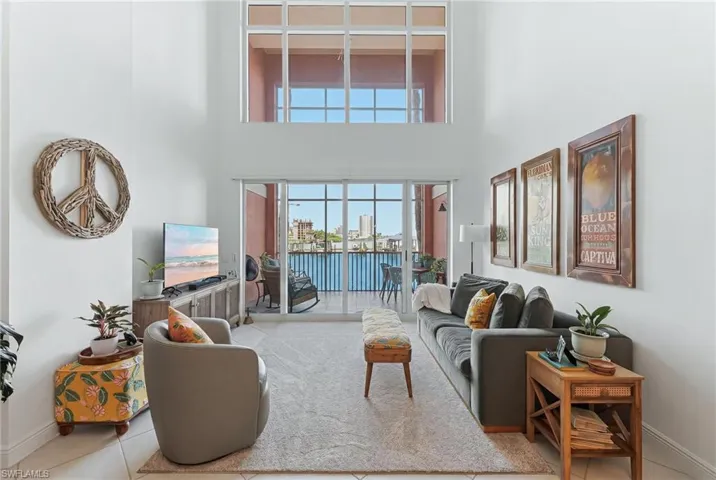 Spacious living area featuring high ceilings and floor-to-ceiling windows