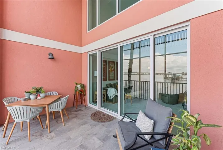 Outdoor patio featuring large format tile flooring and a stucco exterior with white trim