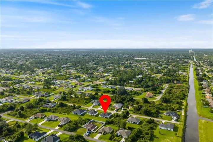 Aerial overview of property's location featuring nearby suburban area
