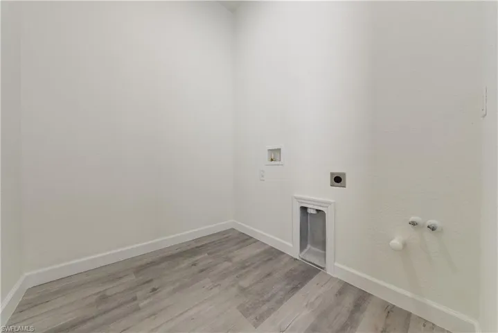 Washroom featuring gas dryer hookup, washer hookup, light wood-style flooring, and electric dryer hookup