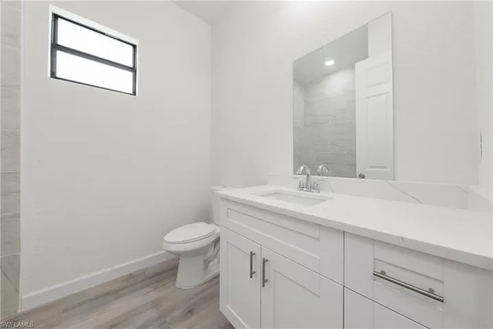 Bathroom with wood finished floors and vanity