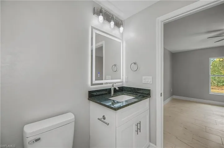 Half bath featuring vanity and a ceiling fan