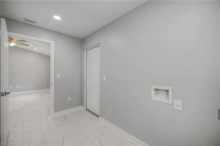 Laundry room with light marble finish flooring, washer hookup, a ceiling fan, and recessed lighting