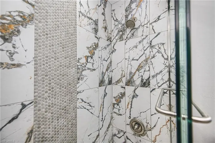 Bathroom view of a marble finish shower