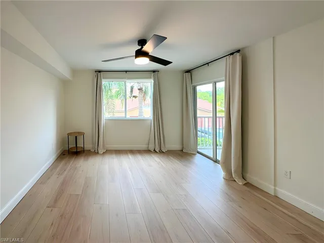 Unfurnished room featuring light wood-type flooring and ceiling fan