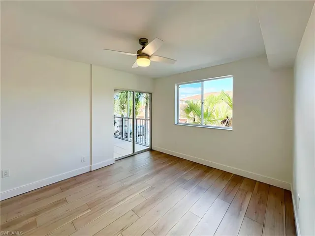Unfurnished room featuring ceiling fan and light wood-type flooring