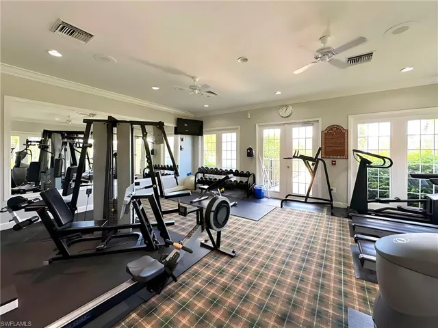 Workout area featuring crown molding and ceiling fan