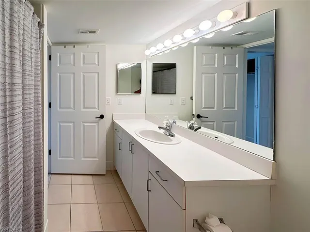 Bathroom with vanity and tile patterned flooring