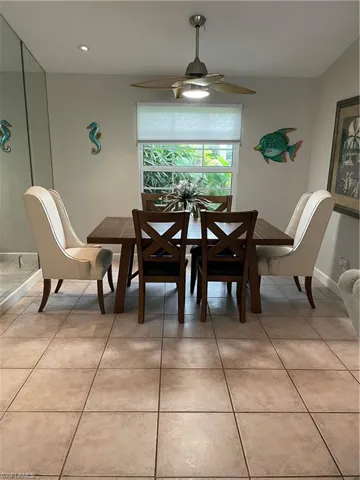 Dining room with light tile patterned floors, recessed lighting, a ceiling fan, and baseboards