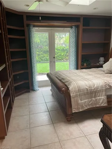 Bedroom with access to exterior, french doors, and light tile patterned flooring